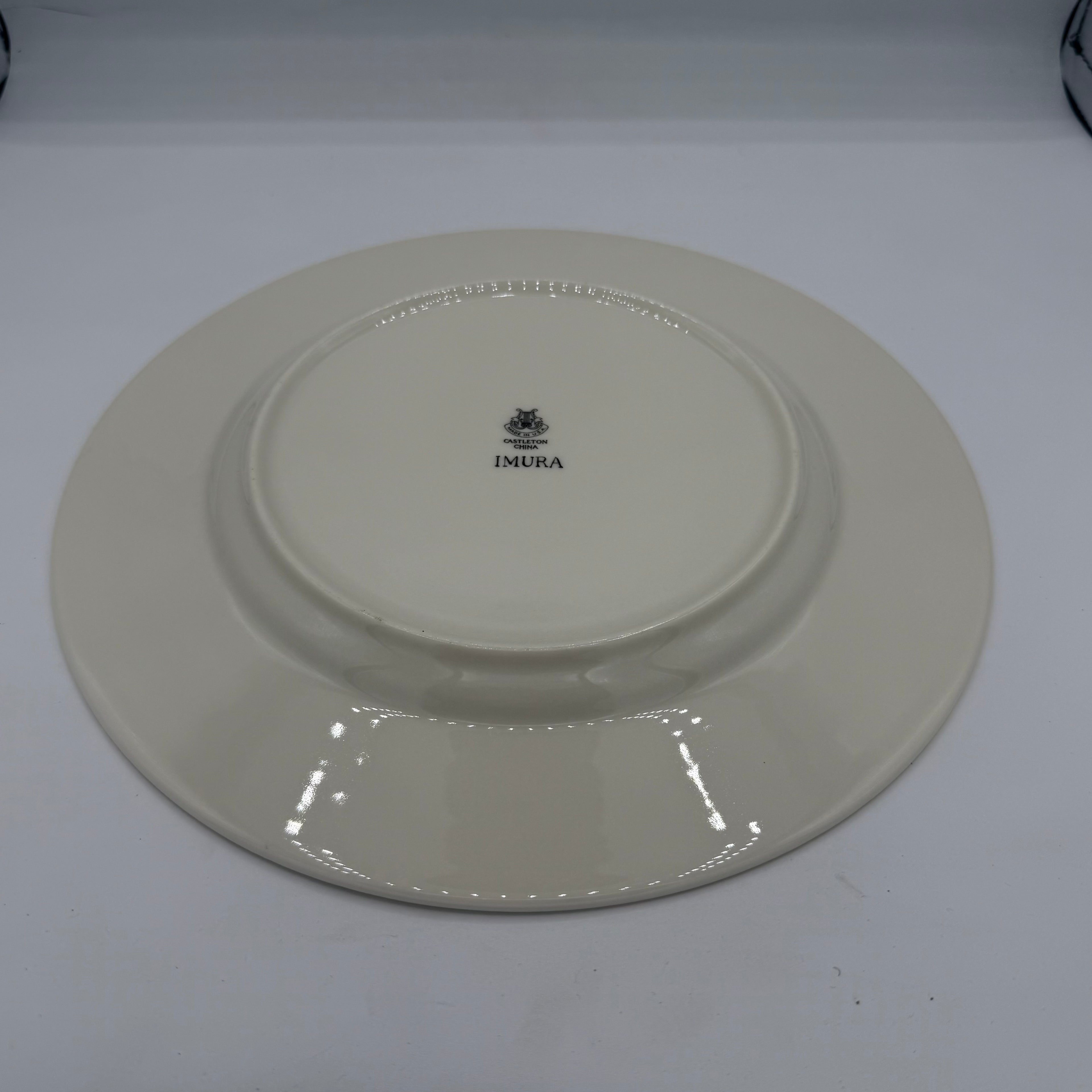 Beige ceramic plate with a visible brand logo on a white background Castleton China Imura